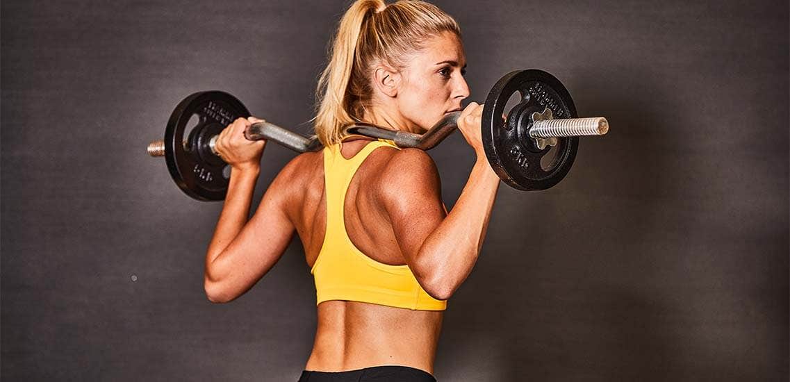 Woman trains effectively with barbell