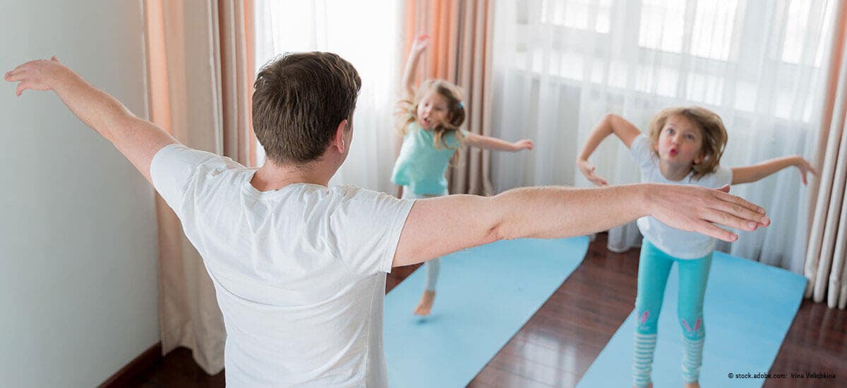 Familenvater treibt Sport mit Kindern zu Hause